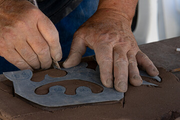 Men cutting clay using a stencil