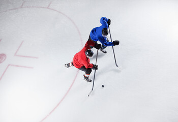 Hockey players going for the puck on ice