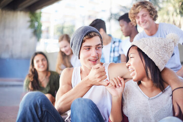 Teenage couple hooking pinky fingers