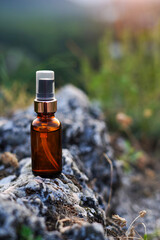 essential oil staying on the stone, nature background with sunset