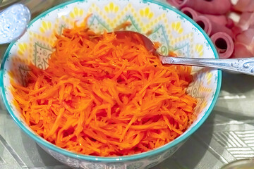 Spicy Korean carrot salad in a bowl close-up.