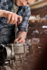 Obraz na płótnie Canvas Mechanic fixing car engine at auto repair shop