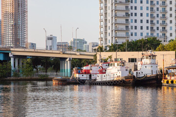 Tug boats at river side in Miami River Drive area
