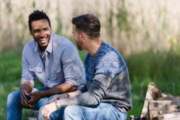 Smiling men talking outdoors