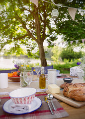Bread and butter on patio table at lakeside