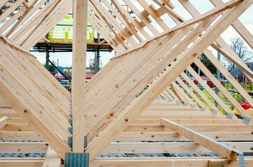 New residential home construction with roof framing joist against a sky - obrazy, fototapety, plakaty