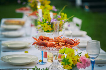 Crayfish in glass bowl on elegant garden party table