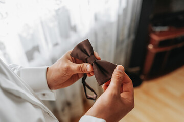 man butterfly clothes,businessman putting on bow tie. Suit, Hands, care, tie, to correct, to...