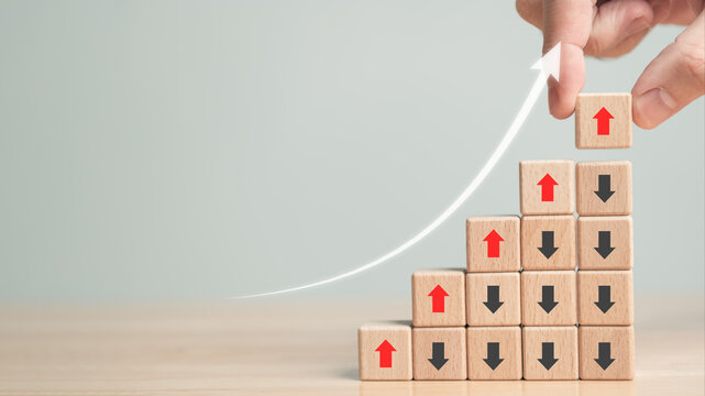 Rising and falling arrow trend. Up and down point arrow on wooden cube block for stock economic and business profit growth and loss concept. Copy space