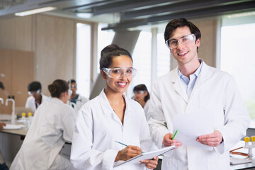 Portrait confident college students in lab coats in science laboratory classroom