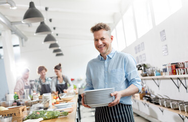 Portrait smiling man in cooking class kitchen