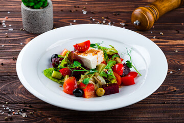 Salad of fresh cucumber, tomato, sweet pepper, lettuce, feta cheese, olives, beets and Dijon mustard.
