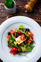 Salad of fresh cucumber, tomato, sweet pepper, lettuce, feta cheese, olives, beets, Dijon mustard and spices.