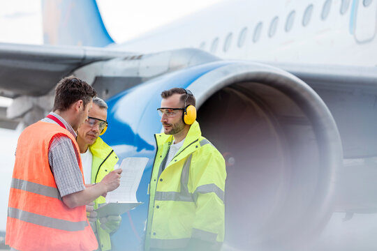 Air traffic control ground crew clipboard next to airplane on tarmac