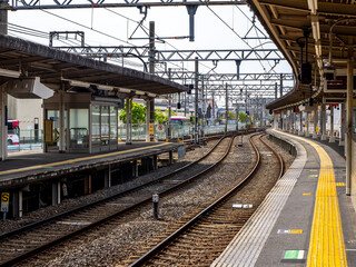 Fototapeta na wymiar Japanese train station. Serene and still, the empty Japanese train station exudes a tranquil ambiance, with platforms awaiting the rush of passengers and echoes of past journeys lingering in the air.