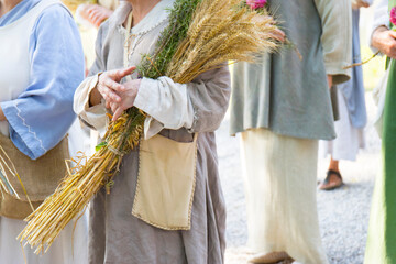 women with basket of grain and flowers