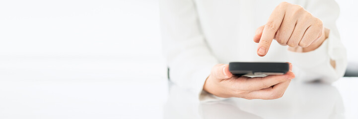 businesswoman using smart phone in office, hand close up. Wide horizontal Panorama cover and header web Banner. Copy space.