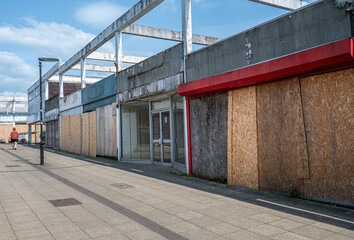 Fototapeta na wymiar Run down and boarded up shopping precinct prior to being rejuvenated in an English town centre.