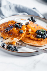 Fresh American Pancakes with orange jam, blueberries and coconut yogurt, perfect breakfast