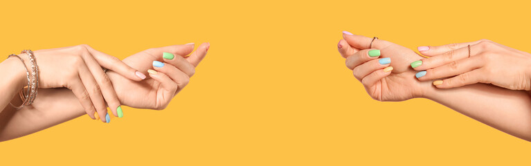 Hands of young woman with beautiful manicure on color background