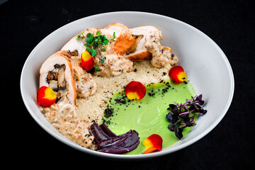 Chicken rolls with mushrooms and onions, sauce, ptitim and microgreens.