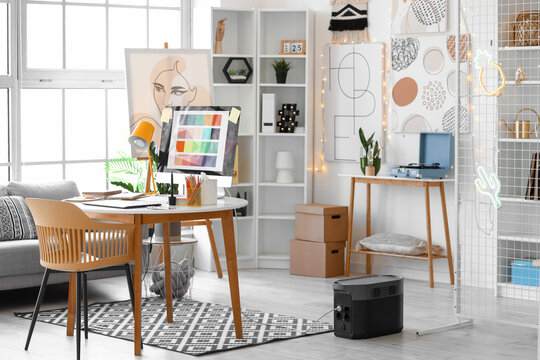 Graphic designer's workplace with computer in interior of office