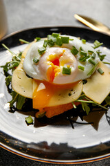 Plate with tasty egg Benedict on table, closeup