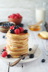 Pancakes with berries in rustic style