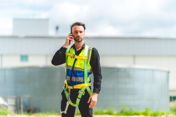 Elegant engineer holding a walkie talkies to working in determined and has a vision like a leader, Discussion and coordination between departments about problem solving, blue collar concept