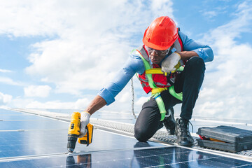 African American engineer maintaining solar cell panels on factory building rooftop. Technician working outdoor on ecological solar farm construction. Renewable clean energy technology concept