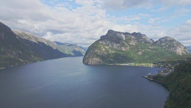 Aerial rotation of a waterfront village near Manafossen Norway