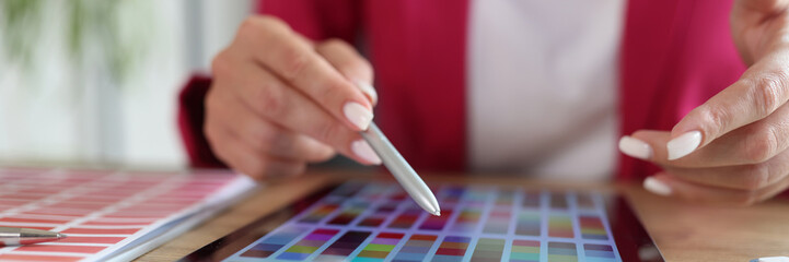 Woman working with color swatches for selection on tablet