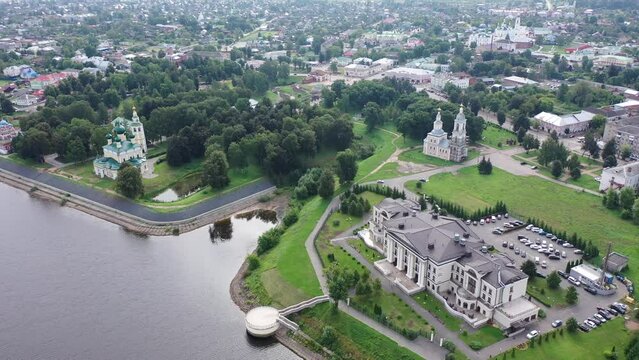 Summer aerial view of modern Uglich cityscape overlooking architectural complex of Kremlin with Transfiguration Cathedral and Church of Dimitry Tsarevich on bank of Volga, Russia