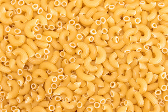 Uncooked Chifferi Rigati Pasta Background. Fat and Unhealthy Food. Classic Dry Macaroni Texture. Italian Culture and Cuisine. Raw Pasta