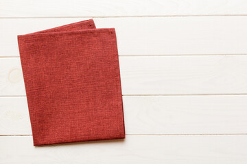 top view with red empty kitchen napkin isolated on table background. Folded cloth for mockup with copy space, Flat lay. Minimal style