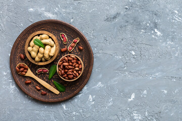 Fresh healthy peanuts in bowl on colored table background. Top view Healthy eating bertholletia concept. Super foods