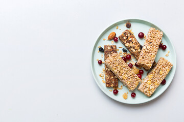 Various granola bars on table background. Cereal granola bars. Superfood breakfast bars with oats, nuts and berries, close up. Superfood concept
