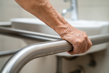 Asian elderly woman use toilet bathroom handle security, healthy strong medical concept.