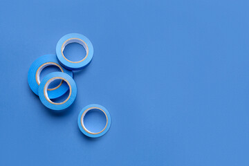 Adhesive tape rolls on blue background