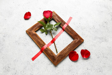 Rose with adhesive tape and frame on grunge background