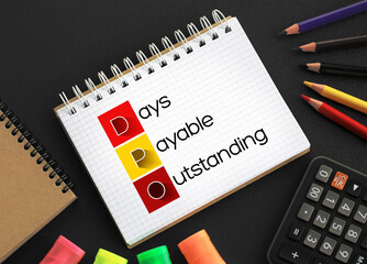 DPO Days Payable Outstanding - efficiency ratio that measures the average number of days a company takes to pay its suppliers, acronym text concept background on notepad