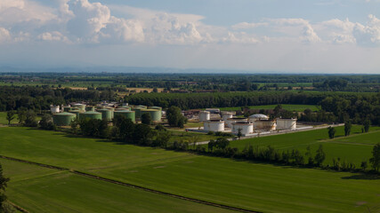 Fototapeta premium Oil refinery plant at sunny day.Ecosystem and healthy environment concepts. Lacchiarella, Italy