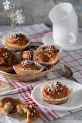 Freshly baked cinnamon buns on a wooden table