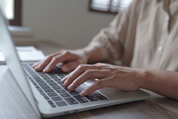 Woman using laptop at home, Selective focus..