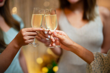 Group of friends celebrating with champagne  Close up on hands.