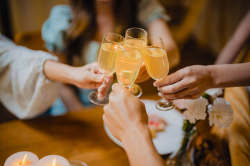 Group of friends celebrating with champagne  Close up on hands.
