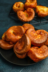 Plate with tasty Yorkshire pudding on blue background