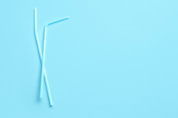 Plastic straws on blue background