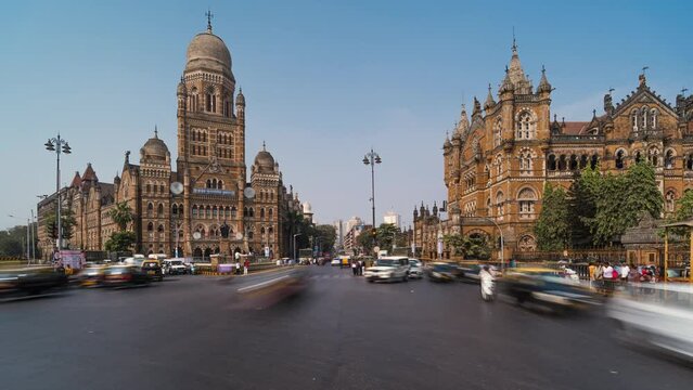 Timelapse view of traffic in front of historic landmarks BMC Building and Chhatrapati Shivaji Terminus aka Victoria Station in South Mumbai, Maharashtra, India, zoom out. 