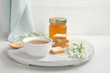 Composition with sweet honey, acacia flowers and crackers on light background, closeup